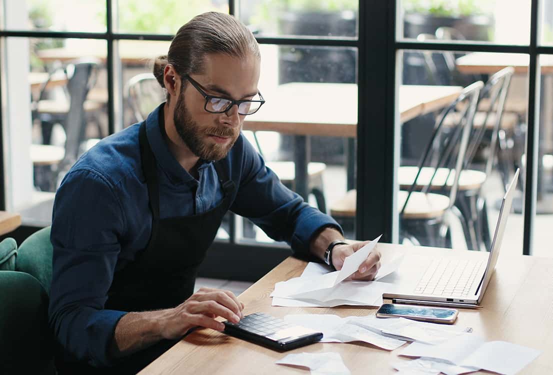 Restaurant owner reviewing statements